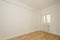 empty room with chestnut wood parquet and freshly painted walls