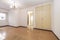 Empty room with cork tile flooring and cream painted wooden