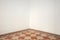 Empty room corner with blank white walls and floral decorated floor