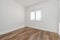 empty room freshly painted with dark wood flooring