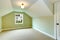 Empty room with green walls and white vaulted ceiling