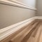 Empty room with hardwood floor and white wall. Baseboard, and molding on walls