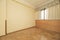 Empty room with herringbone oak flooring, cream painted walls