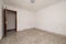 Empty room in a house with terrazzo floors and red woodwork