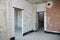 Empty room interior build with white and red bricks, plastering wall, waterproofing floor, metal door lintel