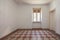 Empty room interior with tiled, decorated floor in a sunny day