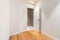 Empty room with laminate flooring and newly painted white walls. Repair and construction concept.