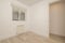 empty room with light wood flooring, plain white paint walls and sliding or sash window