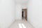 empty room with a mahogany colored door with white painted walls,