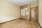 empty room with oak parquet, yellow painted walls and fitted wardrobe