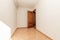 empty room with orange stoneware floor, mahogany wood door