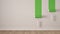 Empty room with paint rollers and painted wall, wooden floor, white and green minimalist interior design