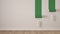 Empty room with paint rollers and painted wall, wooden floor, white and green minimalist interior design