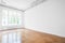 Empty room with parquet floor , white walls and stucco ceiling