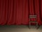 Empty room with red curtain and wooden floor, presentation background with copy space.