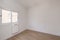 Empty room in renovated apartment with white painted walls, white joinery