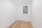 Empty room after renovation with white walls and dust window without natural light. Typical apartment in Barcelona