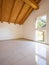 Empty room with a sloping roof and wooden beams