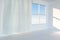 An empty room with sunshine come through the curtain, 3d rendering