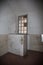 Empty Room with a Toilet in an Old Prison