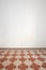 Empty room with white wall and ancient tiled floor in interior