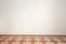 Empty room with white wall and ancient tiled floor in a renovated apartment