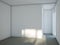 Empty room with white walls and gray cement floor