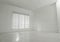 Empty room with white walls, large window and wooden floor