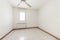 Empty room with wooden baseboards with white ceramic flooring,