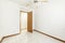 Empty room with wooden door and matching baseboard
