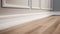 Empty room with wooden floor and white wall. Baseboard, paneling and molding on walls.