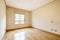 Empty room with wooden parquet, aluminum windows, yellow painted