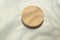 Empty round pastel beige platform podium on white background with natural light and shadows. Mock up background for