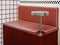 Empty round stainless steel side table fixing on red retro style diner booths.