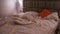 An empty rumpled bed in the hotel. Crumpled blanket and pillows. Close-up of messy bed. Used linens, bed sheet and