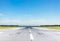 Empty runway at the airport on a sunny clear cloudless day