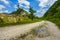 Empty rural road through mountain clifs