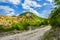 Empty rural road through mountain clifs