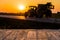 Empty rustic wood table top with tractor silhuette at sunset background. Can montage or display your products