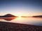 Empty sandy beach in island in romantic colors of tropical sunset. The foot steps in sand.