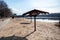 Empty sandy beach with parasols by the river