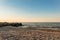 Empty sandy beach in Peresyp resort village. Evening sea landscape. Stacked stone boulders.