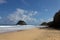 Empty sandy Praia da Conceicao beach under blue cloudy sky in Pernambuco, Brazil