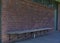 Empty school bench with brick wall on background