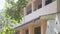 Empty school building with large balcony at green trees