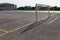 Empty school soccer field playground with goal with net and yellow markings on ground