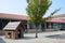 A empty school yard with a playhouse and tree