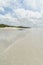 empty seashore under blue sky with clouds, Rarawa beach,