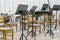 Empty seats and some instruments in music hall awaiting orchestra to come on the stage. black music stand on stage