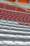 Empty seats in the stands of the arena or auditorium. Rows of red and white seats with no spectators. The concept of the abolition